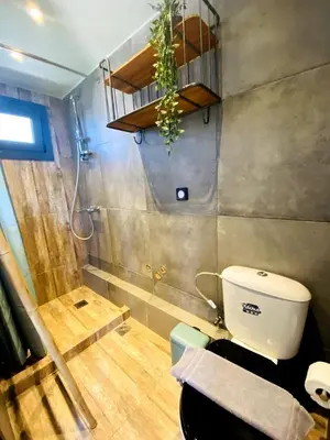 a small bathroom with a toilet and a shower at 200Mbps Wifi - Penthouse With Acropolis View in Athens
