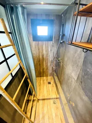 a bathroom with a shower with a wooden floor at 200Mbps Wifi - Penthouse With Acropolis View in Athens