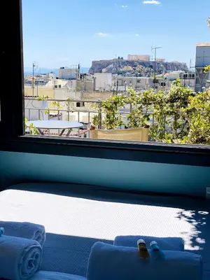 a window with a view of a city at 200Mbps Wifi - Penthouse With Acropolis View in Athens