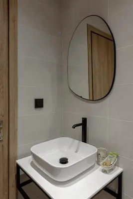 a bathroom with a white sink and a mirror at Galio Suites Airport by Airstay in Spáta