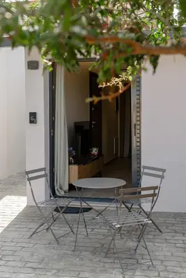 two chairs and a table and a table and chairs at Galio Suites Airport by Airstay in Spáta