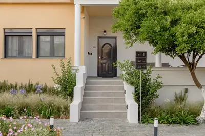 a house with a black door and stairs at Galio Suites Airport by Airstay in Spáta