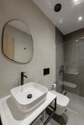 a bathroom with a sink and a toilet and a mirror at Galio Suites Airport by Airstay in Spáta