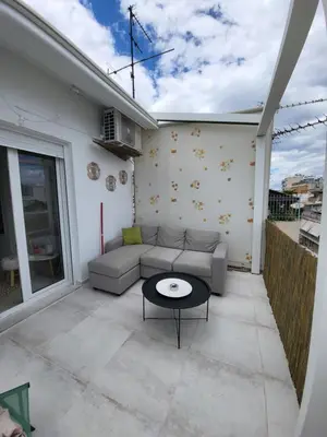 a living room with a couch and a table at Viva La Veranda Apartment in Central Athens in Athens
