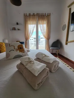 a bedroom with a bed with towels on it at Viva La Veranda Apartment in Central Athens in Athens