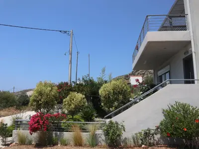a house with flowers on the side of it at Patroclos SeaView in Sounio