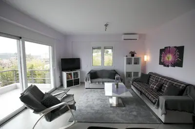 a living room with a couch and a table at Patroclos SeaView in Sounio