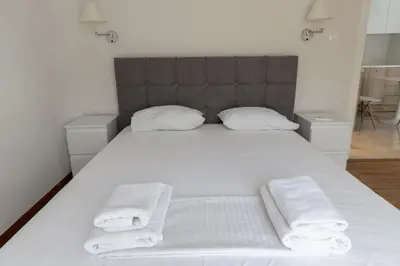 a bedroom with a white bed with towels on it at Acropolis Urban Life in Athens