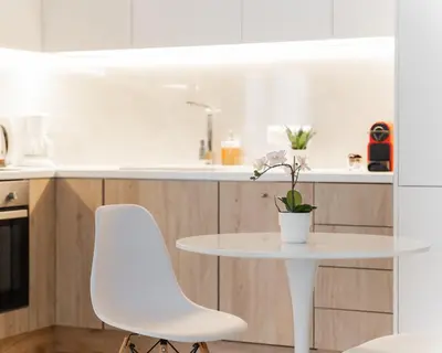 a white table and two white chairs in a kitchen at Acropolis Urban Life in Athens
