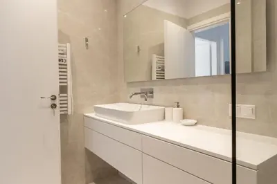 a white bathroom with a sink and a mirror at Acropolis Urban Life in Athens