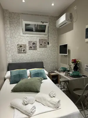 a hospital room with a bed with towels on it at AIOLOS LUXURY alimos market apartment 2 near the sea in Athens
