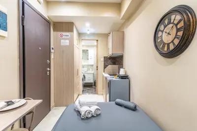 a small room with a clock on the wall at AIOLOS LUXURY alimos market apartment 2 near the sea in Athens