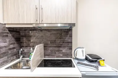 a small kitchen with a sink and a stove at AIOLOS LUXURY alimos market apartment 2 near the sea in Athens