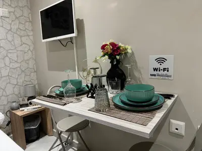 a table with plates and bowls on top of it at AIOLOS LUXURY alimos market apartment 2 near the sea in Athens