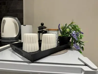 a counter top with a tray of towels and flowers at AIOLOS LUXURY alimos market apartment 2 near the sea in Athens
