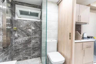 a bathroom with a toilet and a shower at AIOLOS LUXURY alimos market apartment 2 near the sea in Athens