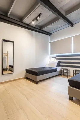 a bedroom with a bed and a mirror on the wall at Ermoo Athens Modern Living in Athens