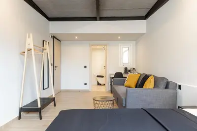 a bedroom with a couch and a living room at Ermoo Athens Modern Living in Athens
