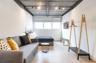 a living room with a couch and a bed at Ermoo Athens Modern Living in Athens