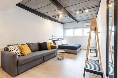 a living room with a couch and a bed at Ermoo Athens Modern Living in Athens