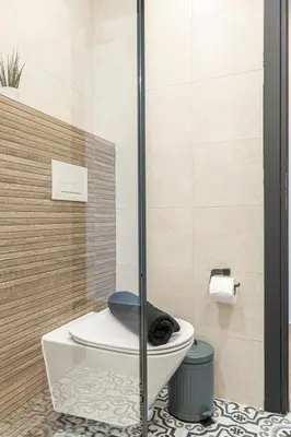 a bathroom with a toilet with a glass shower at Ermoo Athens Modern Living in Athens