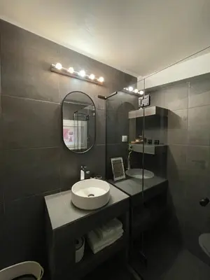a bathroom with a sink and a mirror at Ermoo Athens Modern Living in Athens