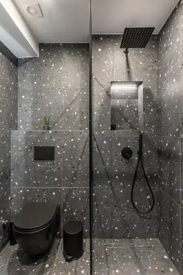 a bathroom with a shower with a black toilet at Ermoo Athens Modern Living in Athens