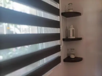 a room with a window with black blinds at Kallimarmaro Refuge in Athens