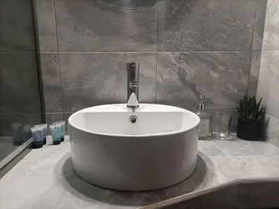 a white bath tub sitting on a counter in a bathroom at Kallimarmaro Refuge in Athens