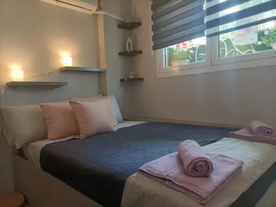 a bedroom with a bed with towels on it at Kallimarmaro Refuge in Athens