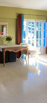 a living room with a table with a vase on it at Villa-Agave , by the sea in Porto-Rafti outside Athens in Porto Rafti