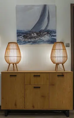 two lamps sitting on top of a wooden cabinet at Max Blue apartment, a stay like no other in Piraeus