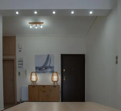 two lamps sitting on top of a room at Max Blue apartment, a stay like no other in Piraeus