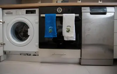 a washer and dryer with two towels on it at Max Blue apartment, a stay like no other in Piraeus