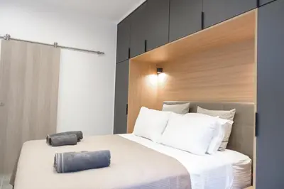 a bedroom with a large bed with two pillows on it at L apartment2 in Athens