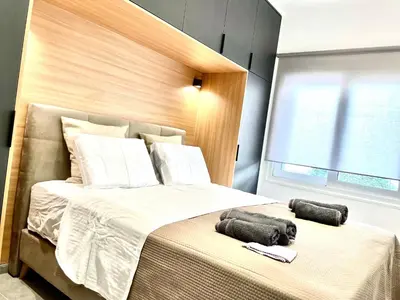 a bedroom with a bed with two towels on it at L apartment2 in Athens