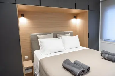 a bedroom with a large bed with two towels on it at L apartment2 in Athens