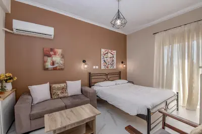 a bedroom with a bed and a couch at Marina Zeas Skydeck in Piraeus