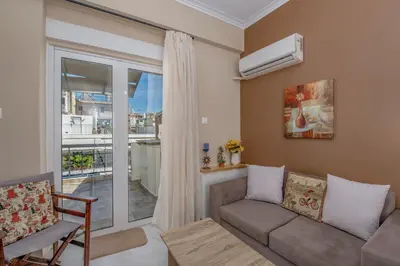 a living room with a couch and a window at Marina Zeas Skydeck in Piraeus