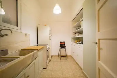 a kitchen with a sink and a refrigerator at Emporikon Apartment Steps From Historic Center in Athens
