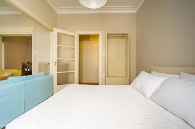 a bedroom with a large white bed in a room at Emporikon Apartment Steps From Historic Center in Athens