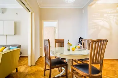 a dining room with a table and chairs at Emporikon Apartment Steps From Historic Center in Athens