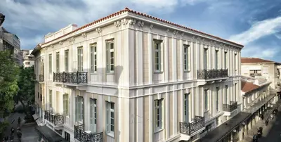 a white building with balconies on the side of it at ATHINAIDOS QUARTERS by K&K in Athens