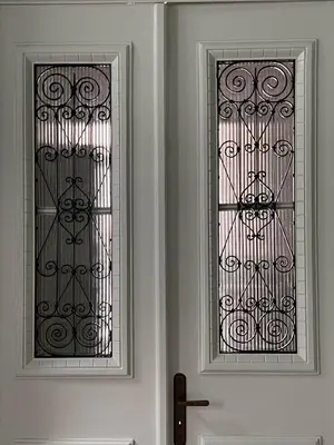 two windows on a white wall next to a door at ATHINAIDOS QUARTERS by K&K in Athens