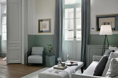 a living room with a couch and a chair at ATHINAIDOS QUARTERS by K&K in Athens