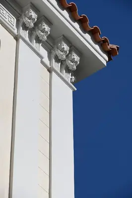 a building with columns and a blue sky at ATHINAIDOS QUARTERS by K&K in Athens