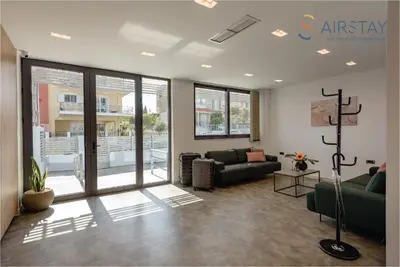 a living room with a couch and a table at Zed Smart Property Airport by Airstay in Spáta