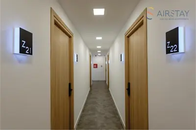 a corridor of a hospital hallway with doors and signs at Zed Smart Property Airport by Airstay in Spáta