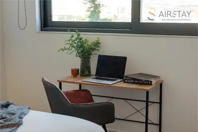 a desk with a laptop and a plant on it at Zed Smart Property Airport by Airstay in Spáta
