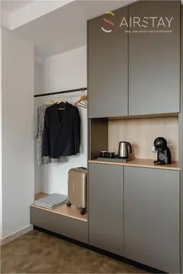 a kitchen with white cabinets and a shelf with a shirt at Zed Smart Property Airport by Airstay in Spáta